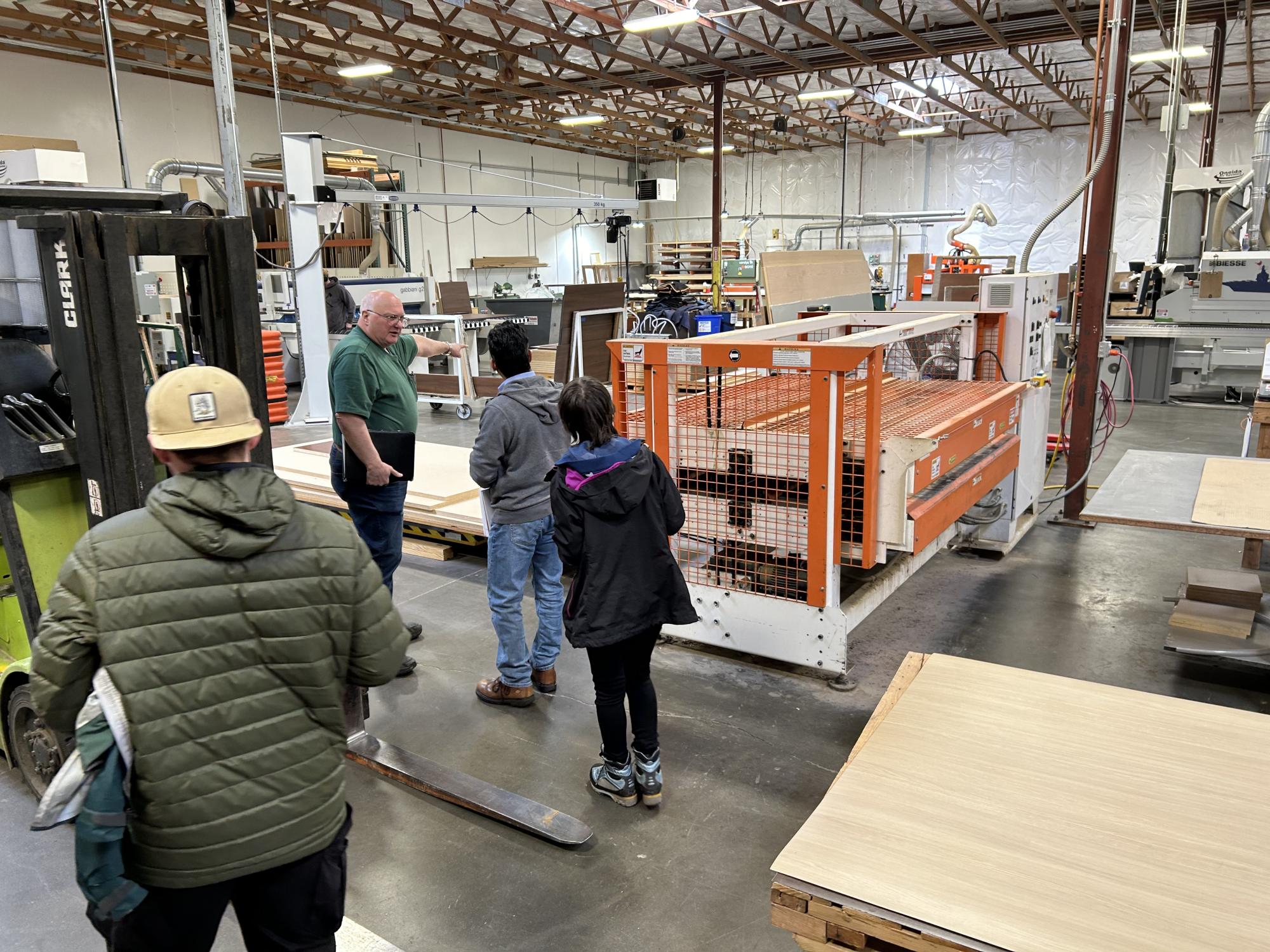 A group of people in a manufacturing facility